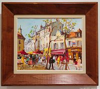 Frontal view of framed painting showing Paris street scene with buildings, trees, and figures under red and yellow awnings