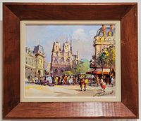Frontal view of the framed original oil painting depicting a vibrant Parisian street scene with Notre-Dame Cathedral, showing the vintage wood frame and legible artist signature.