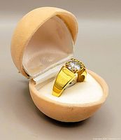 Silver gold rhodium plated solitaire ring with large round Moissanite stone in beige velvet box.