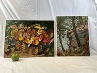 Both paintings displayed side by side with green apple for scale.