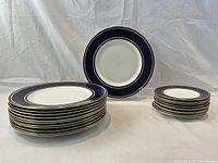 Overview of all plates stacked in two piles with one plate upright