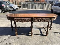 Front view of walnut console table showing overall shape and proportions