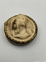 Front view at slight angle showing full relief and frame