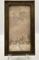 Front view of the framed oil painting showing the winter town scene with snow and church spires under a cloudy sky.