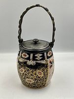 Front view of Imari biscuit barrel showing pattern and handle