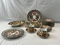 Full overview of set showing plates, platter, cups, saucers, creamer and sugar bowl