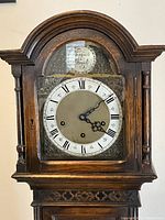 Close-up of clock face showing Roman numerals and 'Tempus Fugit' inscription