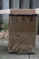 Closed shipping box labeled with Elk Lighting logo and product details.