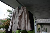 Evan Piccone light beige linen lady's suit jacket hanging outdoors on hanger, single button jacket with notch lapel