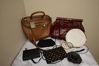 Six vintage purses displayed including leather handbags and beaded evening bags.
