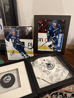 Framed signed photos of Vancouver Canucks players and framed signed jersey with multiple signatures