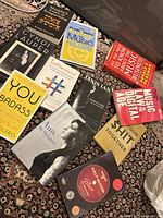 Photo showing all eleven books arranged on a patterned fabric, clearly displaying book titles and covers related to music industry and biographies.