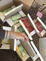 Multiple open boxes containing birthday cake candles in vibrant colors with numbers 0-9 visible inside.