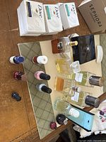 Photo showing assortment of perfumes, nail polishes, and Dove soaps on a surface.
