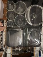 Top-down photo showing the nine glass pieces including bowls, baking dishes, and cake stand.