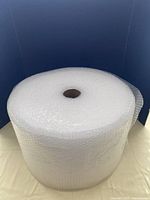 Front view of large clear bubble wrap roll showing size and cardboard core.