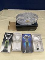 First image showing Studio Nova jewelry box together with the two Mikasa wine bottle stoppers in original boxes, stoppers have clear decorative tops with different styles.