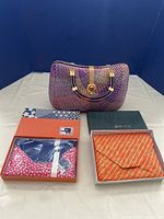 Full lot of three vintage purses showing worn woven purse and two unopened purses in boxes