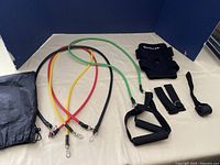 Full set of resistance bands with handles, legging straps, knee wrap, door strap, and carry bag