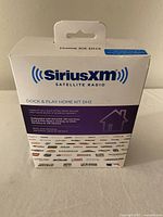 Front view of the Sirius XM Satellite Radio DH3 Dock & Play Home Kit retail box detailed with brand and model info.