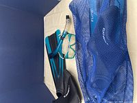 Full set of snorkel gear including fins, mask, snorkel, wetsuit boots and mesh carry bag.