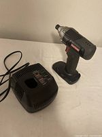 Photo showing Craftsman impact driver and charger side by side on a white surface.