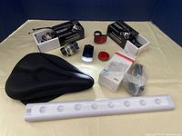 Overview of all bicycle accessories including padded seat, lights, reflectors, phone holder, and LED strip light.