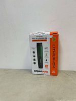 Front view of boxed Conair Man 16-piece lithium-ion cordless trimmer kit showing product branding and main features