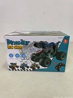 Front and top view of box showing the dinosaur RC car image with LED light, chip function, sound function icons and the age 3+ indication