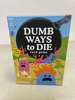 Front of the Dumb Ways to Die card game box showing title, age range of 12+, and number of players 2-5.