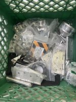 Crate of assorted metal hinges, mounting brackets, connectors and tool accessories