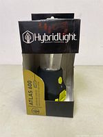 Front view of HybridLight Atlas 600 lantern in original retail packaging showing product name, brand, and part of the lantern.
