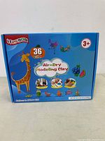 Front side of box showing Ifergoo 36 color air-dry modeling clay with examples of animal and fruit models made from clay, recommended for ages 3+.