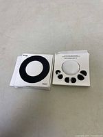 Box and instruction manual with multiple black ear tips displayed inside packaging layout.