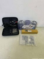 Full view of all items in the lot showing the tool kit, filter, lug nuts, and cleaning stick