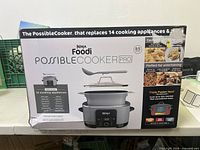 Box showing the Ninja Foodi PossibleCooker Pro, listing its capability to replace 14 cooking appliances and oven safe to 500°F with easy-to-clean nonstick pot.