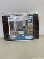 Packaged waterproof recliner chair cover with image showing installation on a recliner chair and product name