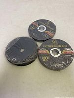 Three Vevitts metal cutting wheel discs laid out, showing labels with size and speed rating.