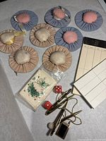 Bridge markers, score pads, red dice, and gold-toned accessories displayed on a flat surface.