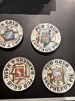 Four vintage English ceramic pub plates showing Fish & Chips, Cottage Pie, Shepherd's Pie, and Bangers & Mash.