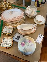 Overall view of assortment showing lidded serving dish, gravy boat, teacups, saucers, and decorative plates.
