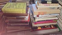 Additional stack focusing on 'L'Arte Di Mangiare Bene' yellow covered books, as well as more from seller's collection