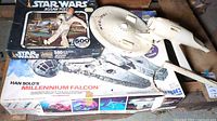 Photo of the Millennium Falcon puzzle box, Han Solo figure on top, and Millennium Falcon model parts visible.