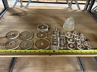 Overview photo of all glass stem parts laid flat on wood surface with measuring tape showing sizes around 5 inches wide