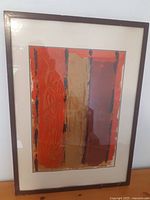 Full view of the framed abstract painting showing the three vertical color bands and gold human figure sketches.