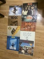 Front covers of eight AC/DC vinyl LPs arranged in two columns of four