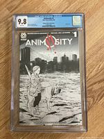 Front cover of Animosity #1 CGC graded 9.8. Black and white sketch edition cover art featuring a young girl and a dog in an urban setting.