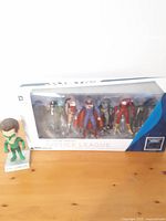 Justice League 7-pack action figure set in original box displayed with loose Green Lantern bobble head.