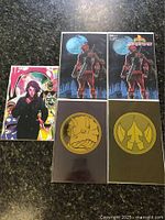 Five Power Rangers comics with colorful and gold-themed cover art laid out on dark surface, showing two Darkest Hour #116 Foil Power Coin Virgin Variants, one Mighty Morphin Power Rangers The Return #1 1:10 Virgin Variant, and two Escorza Last Ronin Homage covers.