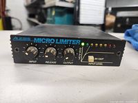 Front view of Alesis Micro Limiter showing control knobs, LED meters, and branding.